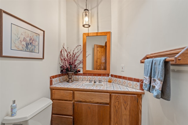 bathroom featuring vanity and toilet