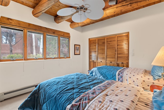 carpeted bedroom featuring wood ceiling, ceiling fan, a baseboard heating unit, beamed ceiling, and a closet