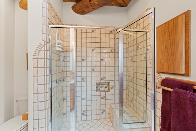 bathroom featuring toilet and an enclosed shower