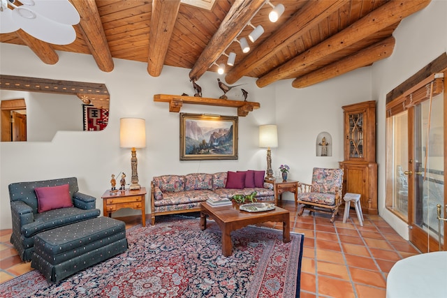 living room with rail lighting, wood ceiling, ceiling fan, beam ceiling, and light tile patterned floors