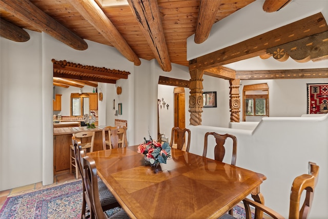 tiled dining room featuring vaulted ceiling with beams, ornate columns, and wooden ceiling