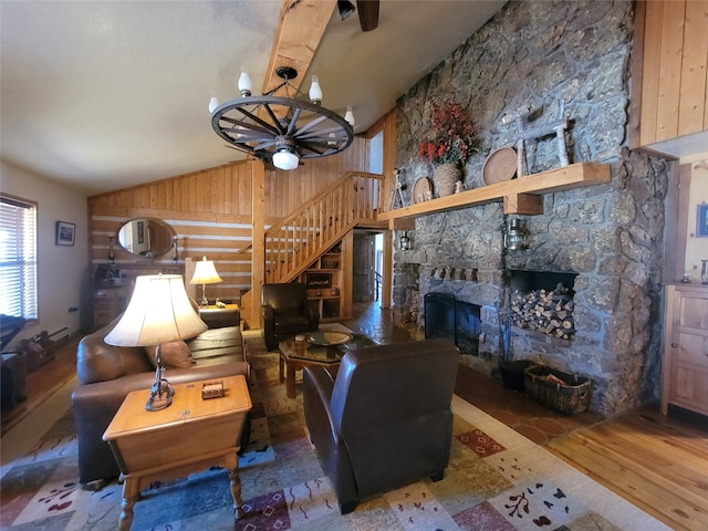 living room with lofted ceiling, a stone fireplace, wooden walls, hardwood / wood-style flooring, and ceiling fan