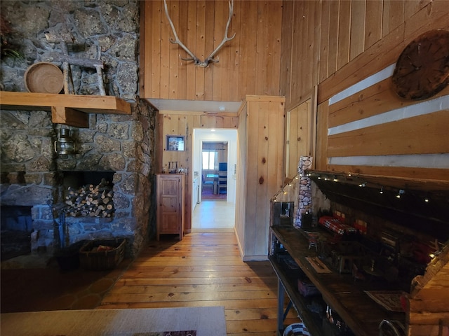 interior space with wooden walls, wood-type flooring, and a high ceiling