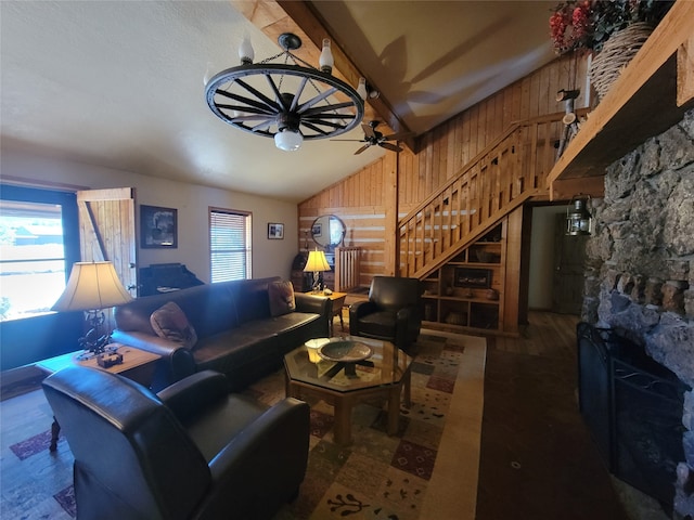 living room featuring ceiling fan, wood-type flooring, lofted ceiling, and wooden walls