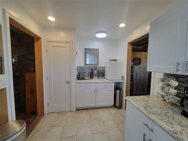 kitchen with white cabinets and decorative backsplash