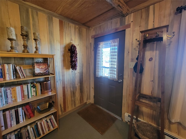 entryway featuring a baseboard heating unit, wooden ceiling, and wooden walls