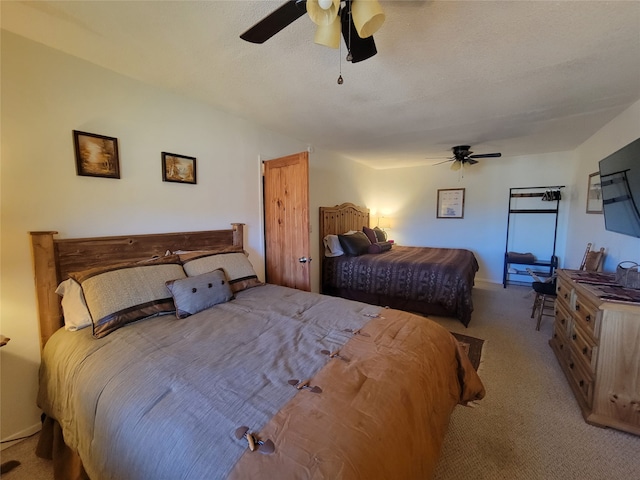 carpeted bedroom with a textured ceiling and ceiling fan