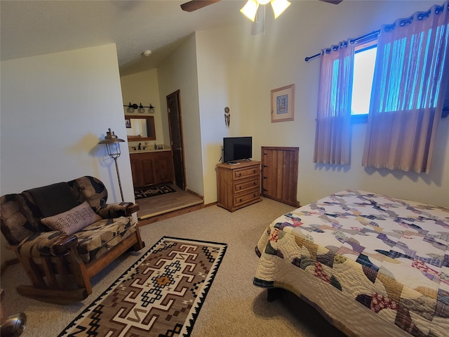 carpeted bedroom with connected bathroom and ceiling fan