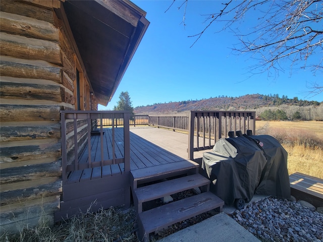 wooden terrace featuring a grill