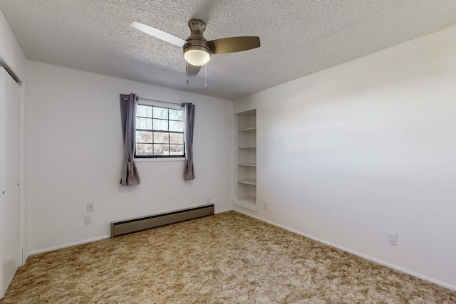 spare room with light carpet, a textured ceiling, baseboard heating, and ceiling fan