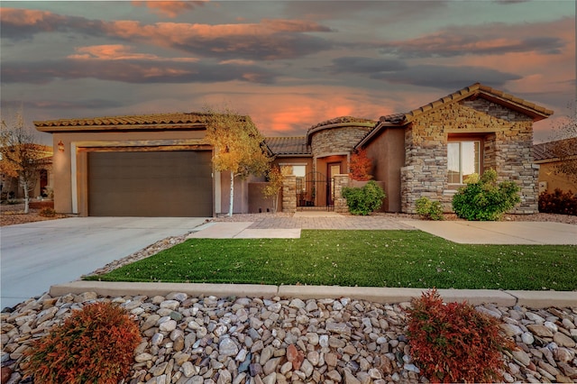 view of front of property featuring a lawn and a garage