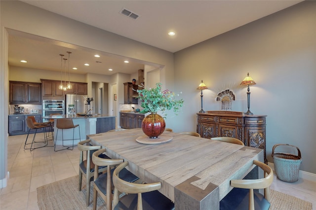 dining space featuring light tile patterned floors