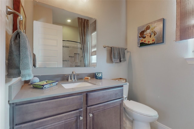 bathroom with a shower, vanity, and toilet