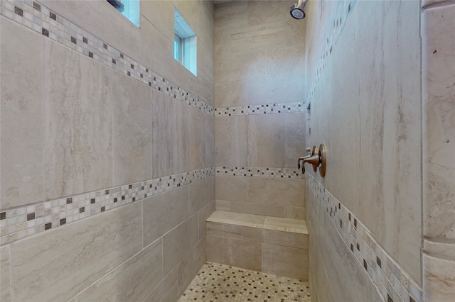 bathroom with a tile shower