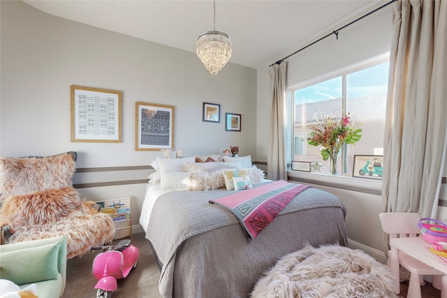 bedroom featuring carpet floors and an inviting chandelier