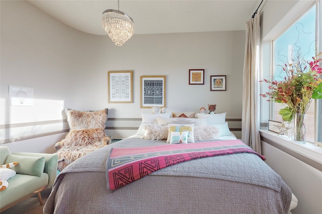 bedroom with a chandelier and multiple windows