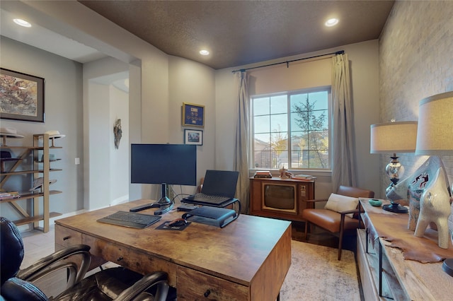 office space featuring light hardwood / wood-style floors and a textured ceiling