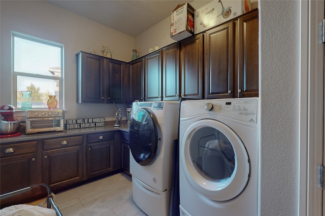 laundry room with separate washer and dryer, cabinets, and a textured ceiling