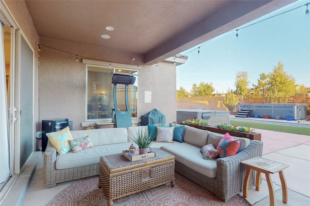 view of patio / terrace featuring an outdoor living space and a hot tub