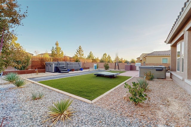 view of yard with a patio area and a hot tub