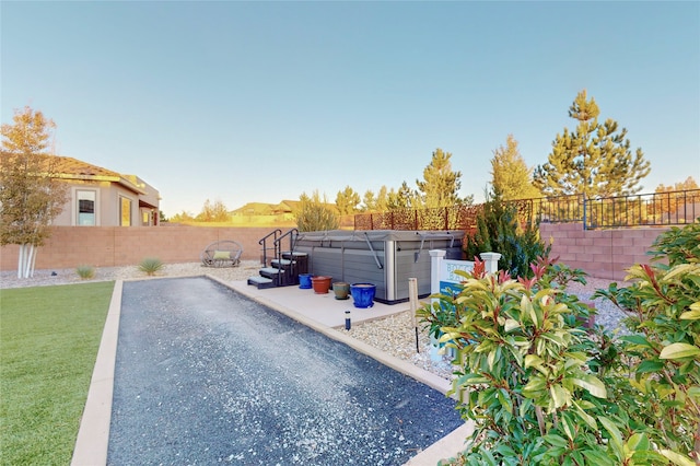 exterior space featuring a patio area and a hot tub