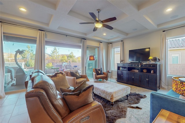 living room with light tile patterned floors, a healthy amount of sunlight, and coffered ceiling