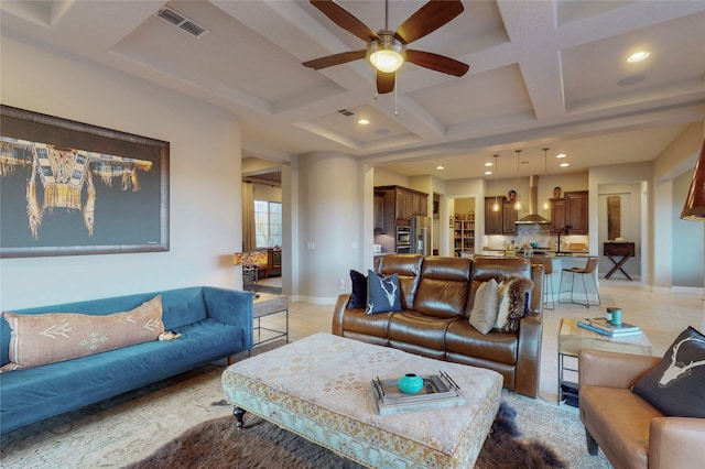 living room with beam ceiling, ceiling fan, and coffered ceiling