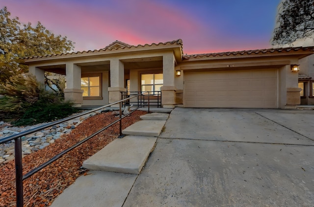 view of front of house featuring a porch and a garage