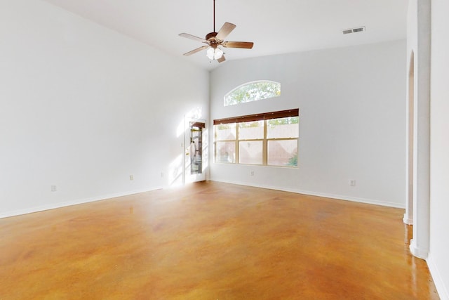 unfurnished living room with ceiling fan and high vaulted ceiling