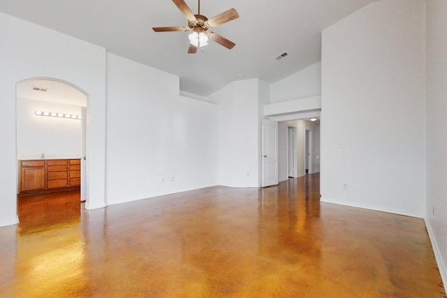 unfurnished room with ceiling fan and high vaulted ceiling