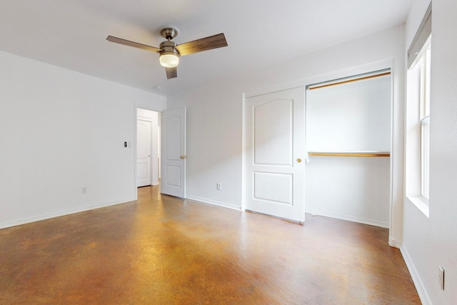 unfurnished bedroom featuring concrete floors, a closet, and ceiling fan