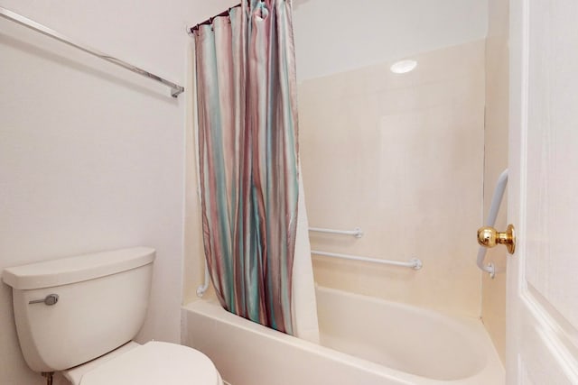 bathroom featuring shower / bath combo and toilet