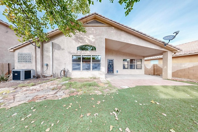 back of house with a lawn, a patio area, and central air condition unit