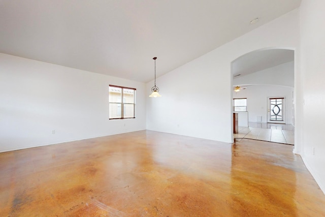 unfurnished room with ceiling fan and vaulted ceiling