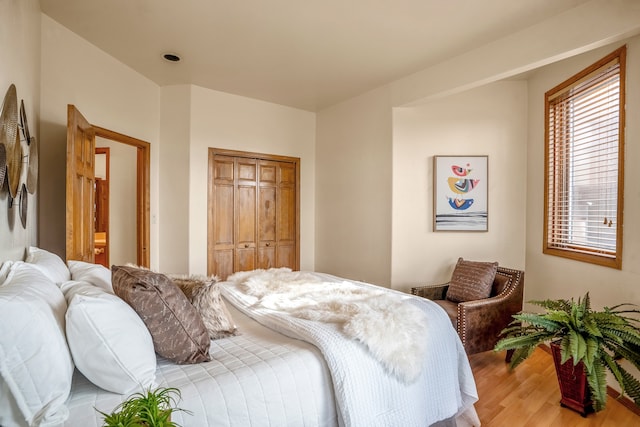 bedroom featuring light hardwood / wood-style floors and a closet