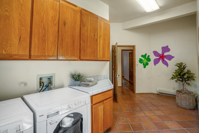 laundry room featuring dark tile patterned floors, cabinets, independent washer and dryer, and baseboard heating