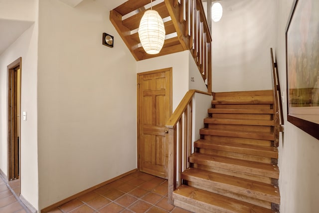 stairway with tile patterned floors