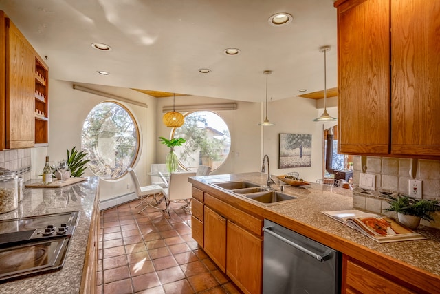 kitchen featuring appliances with stainless steel finishes, backsplash, baseboard heating, sink, and decorative light fixtures