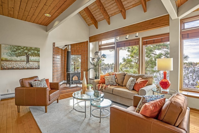 living room featuring a wood stove, wooden ceiling, a baseboard heating unit, and light wood-type flooring