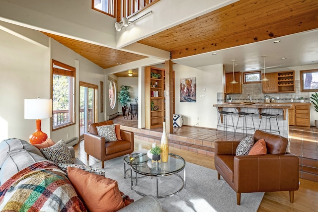 living room with light hardwood / wood-style floors, wooden ceiling, sink, and a baseboard heating unit