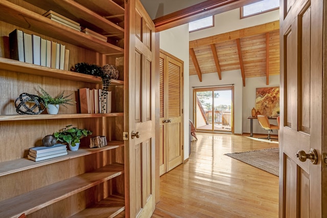 entryway featuring vaulted ceiling with beams, wooden ceiling, and light hardwood / wood-style floors