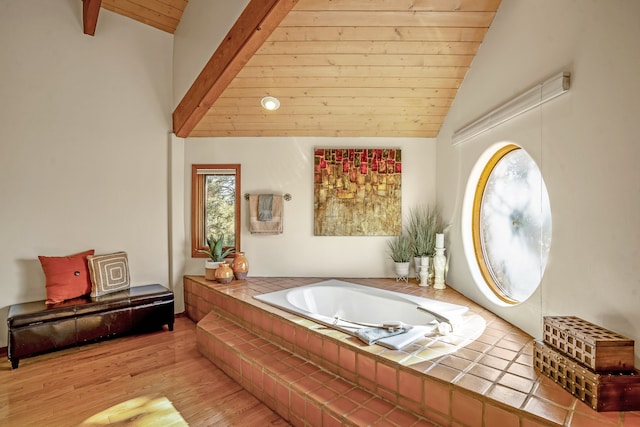 bathroom with wood ceiling, a bath, lofted ceiling with beams, and wood-type flooring