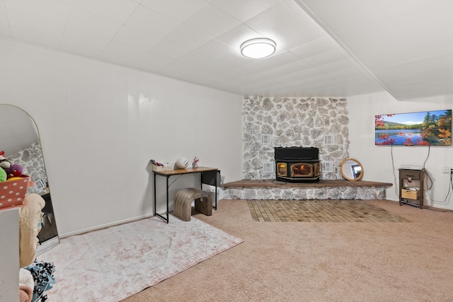 living room with a wood stove and carpet floors