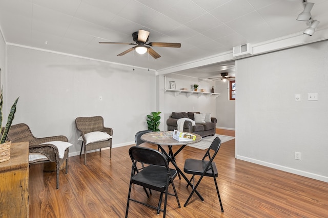 dining space featuring hardwood / wood-style floors, ceiling fan, and ornamental molding