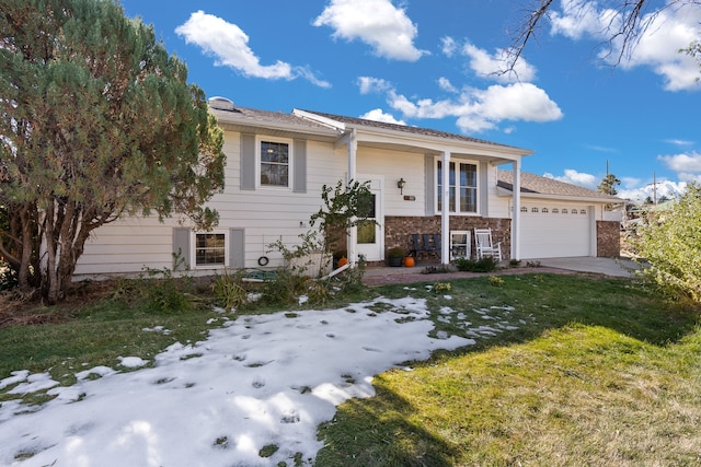 split foyer home featuring a yard and a garage