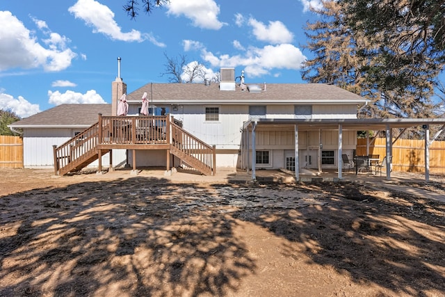 back of house featuring central AC, a patio area, and a wooden deck