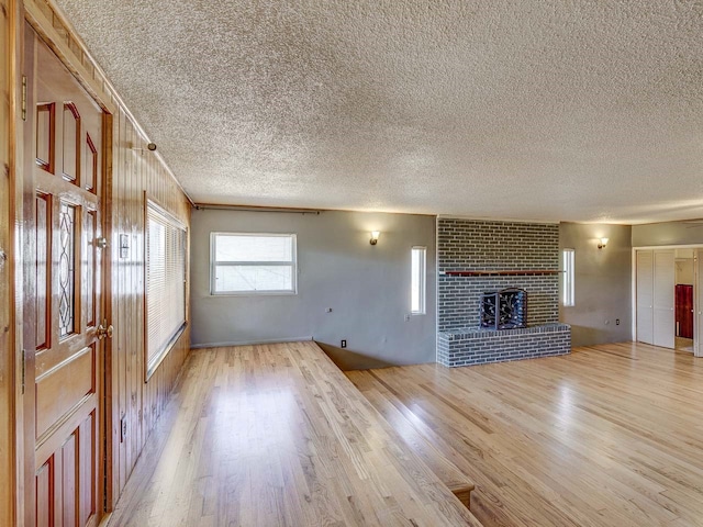 kitchen featuring decorative backsplash, appliances with stainless steel finishes, light wood-type flooring, a kitchen island, and a breakfast bar area