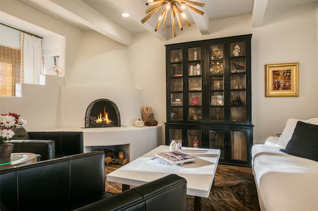 living area with a notable chandelier, beam ceiling, and a fireplace