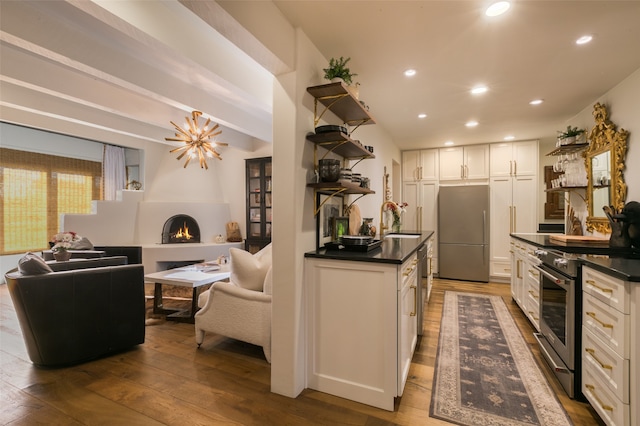 kitchen with white cabinetry, sink, wood-type flooring, and appliances with stainless steel finishes