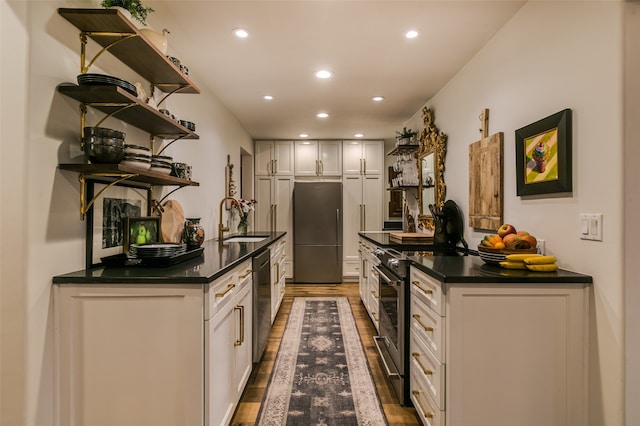 kitchen featuring white cabinets, hardwood / wood-style floors, stainless steel appliances, and sink